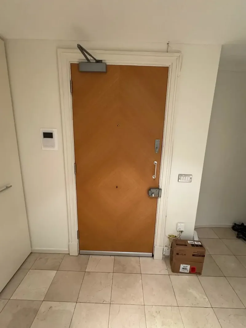 Completed fire door installation with overhead self-closer in Northampton